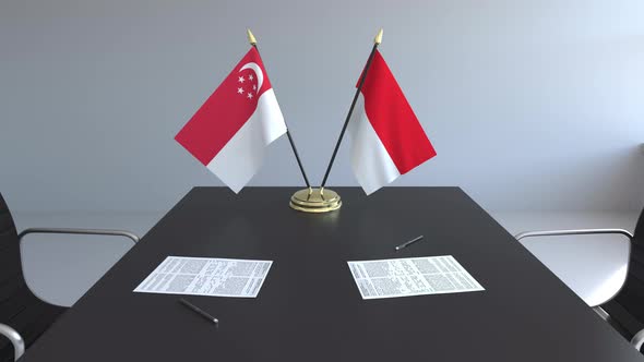 Flags of Singapore and Indonesia on the Table alt