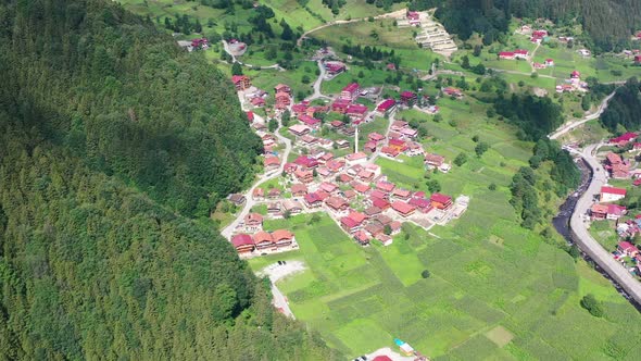 aerial top down view of a small village in Uzungol Trabzon with homes covered in red roofs and large alt