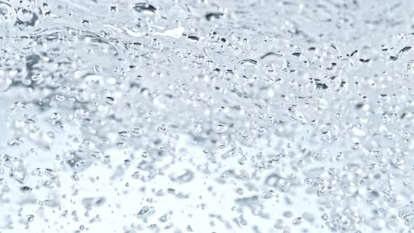 Super Slow Motion Shot of Clear Water Wave And Bubbles Isolated on White Background at 1000Fps alt