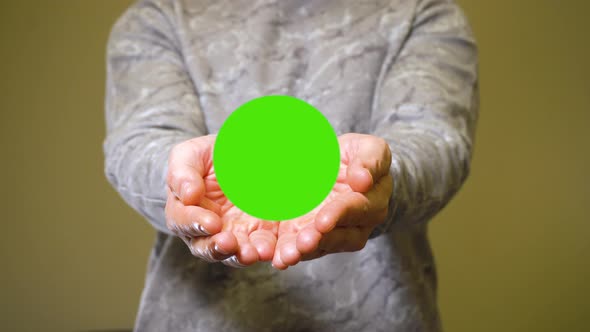 Man Opens His Palms and Show Green Screen Chromakey Banner for Advert or Product