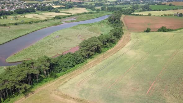 4K, Aerial pan across coastal farmland by an ocean inlet river alt