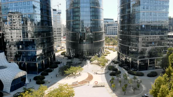 Complex of Contemporary Buildings with Glass Mirrored Walls Located in Modern City District in Sunny