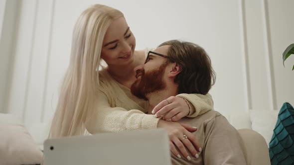 Adorable Millennial Couple Cuddling and Looking Each Other in the Eye Trustful and Happy alt