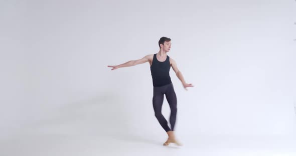 Elegant Man Ballet Dancer Performs Acrobatic Elements and Pirouette Ballet Dance on a White alt