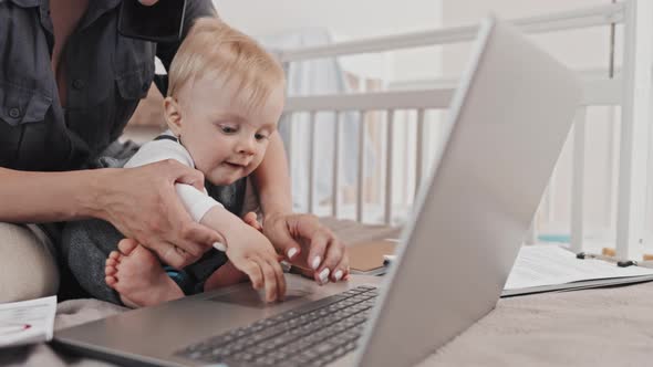 Woman Working and Babysitting at Home alt