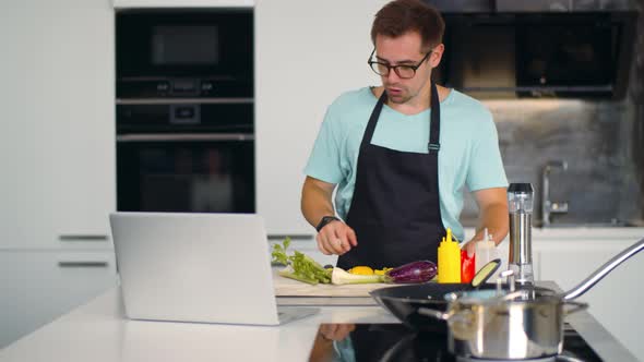 Professional Man Chef Teaching How To Cook Via Video Conference on Laptop alt