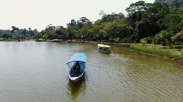 Slow and calm 4k daytime video with two boats floating into opposite directions on the Laguna de los alt