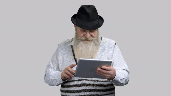 Old Retired Grandpa Starting Online Conversation Using His Tablet Pc alt