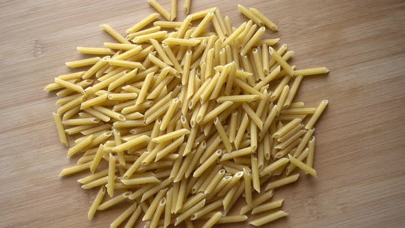 Uncooked macaroni pasta rotating alt