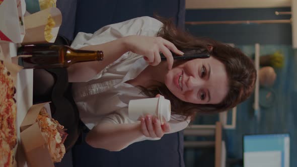 Vertical Video Caucasian Adult Enjoying Phone Call with Friend in Living Room alt