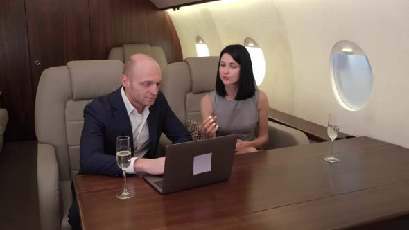 Young Couple Man Woman Working At A Computer Discussing A New Project Drinking  alt