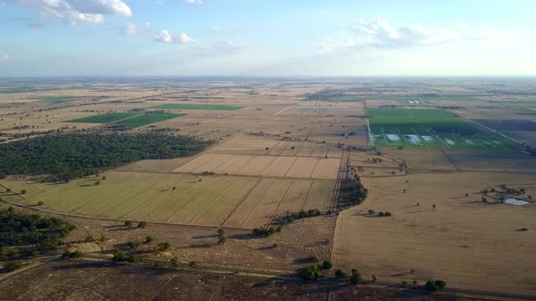 Aerial view over rural Australia, characterized by agricultural land, carved into a neat patchwork o alt