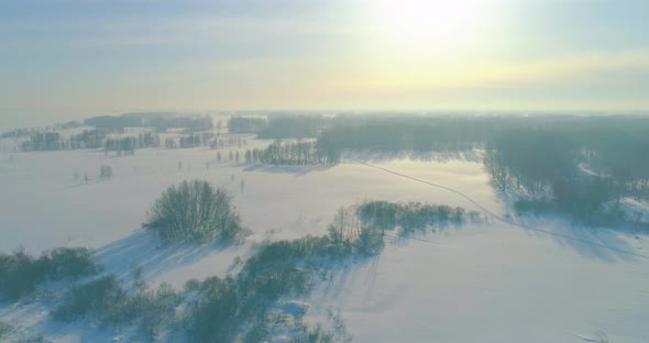 Aerial View of Cold Winter Landscape Arctic Field Trees Covered with Frost Snow Ice River and Sun alt