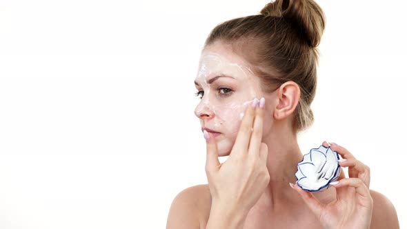 Woman Applying Mask Cream on Face