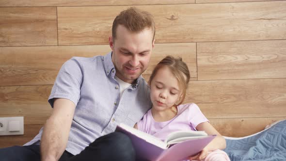 Happy Dad and Child Girl Spend Time Reading Book at Weekends