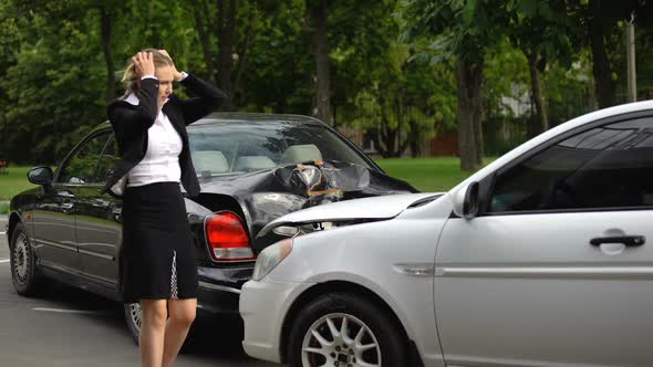 Frustrated Woman Observing Car Damage After Rear-End Collision on Parking Lot alt