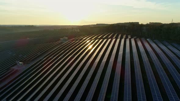 Aerial Drone Footage. Flight Over Solar Panel Farm at Sunset Autumn Season.