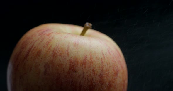 Apple rotating close-up / macro with water spray slowmotion 4k