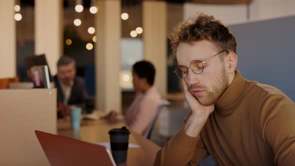 Tired and Stressed Businessman with Headache Working at His Office alt
