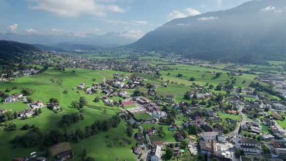 Aerial View of Liechtenstein with Houses on Green Fields in Alps Mountain Valley alt