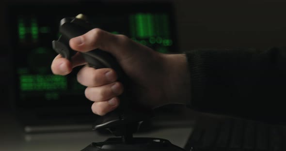 Hand of a Military Pilot Controls a Remote Spy Surveillance Drone for Warfare alt