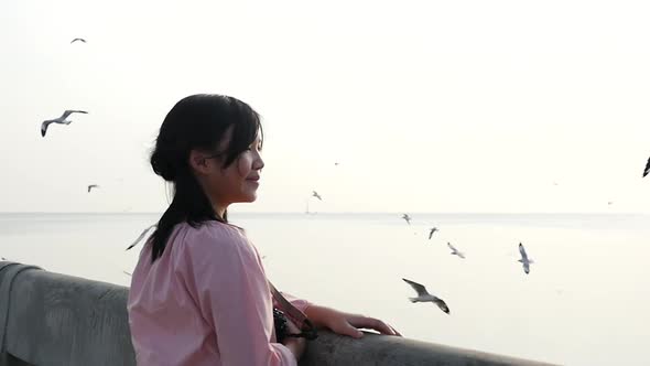 Asian Children Looking The Seagulls On The Bridge, Sunset Time Slow Motion alt