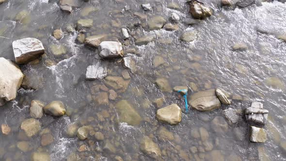 Flying Over Wild Mountain River Flowing with Stone Boulders and Rapids alt