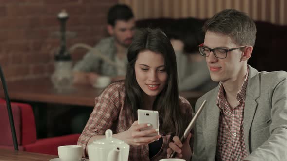 Couple in Love Enjoying Time in a Hookah Club and Taking Selfie alt