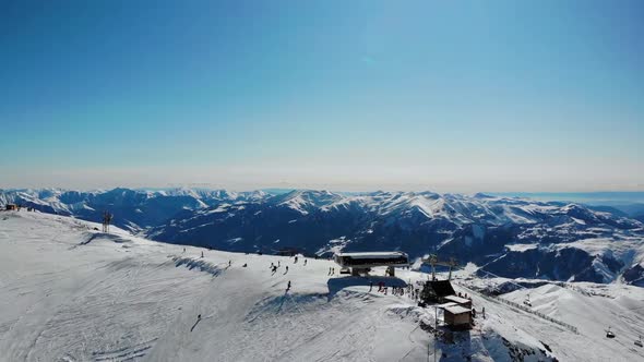 Unrecognizable Tourists Riding From Snowy Hill Top. alt