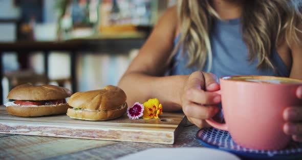 Young Woman Drinking Coffee alt