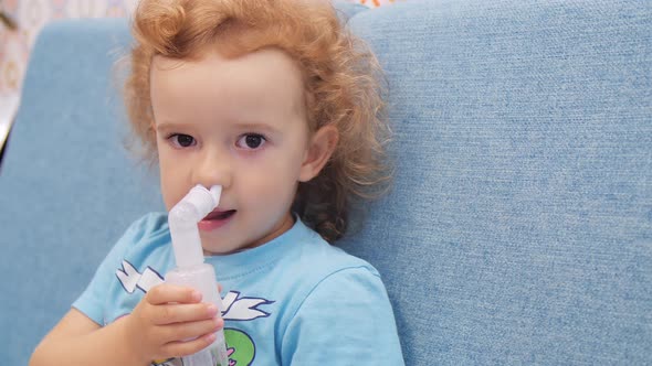 Little Child Makes Inhalation with Nebulizer. Close Up alt