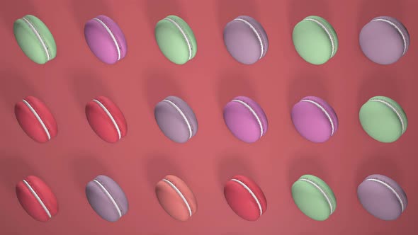 Multicolored macaron pastries  on light red paper background