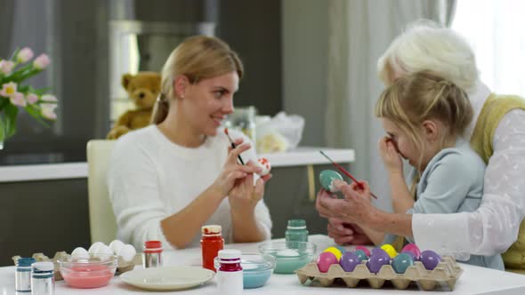 Women Decorating Easter Eggs for Holiday alt