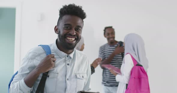 Standing in University Enviroment with His Friends Have Team Meeting in the Background alt