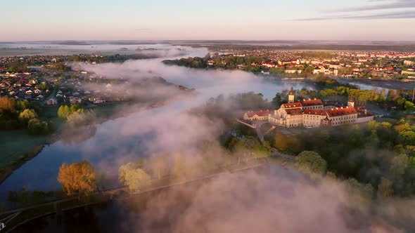 Amazing Dawn in the Foggy Nesvizh, Fog Over the River. Nesvizh. Ancient Castle . Belarus alt
