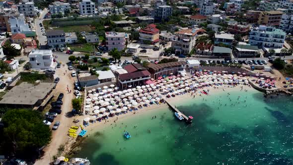Albania view from the drone shooting on the beach beach with umbrellas alt