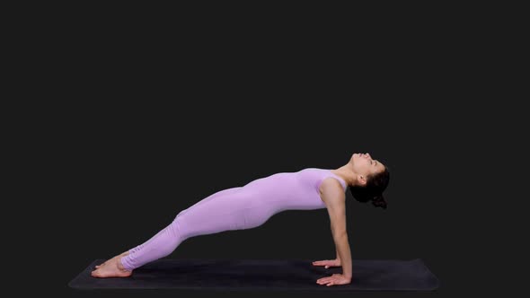 Young Woman Doing Reverse Table Posture and Upward Plank Pose while Practicing Yoga, Alpha in