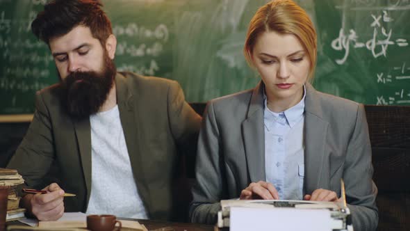 Young Professor Holding Pile of Books. Male University Professor. Math Formulas on Blackboard alt