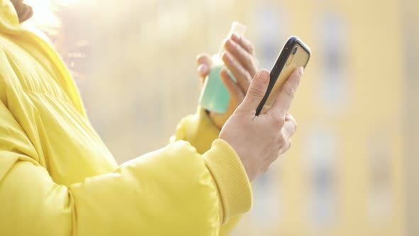  Woman using spray on the smartphone.