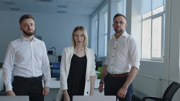 Cool Team Stand in Their Office Company alt