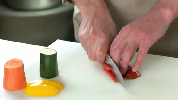Male Hands Cutting Paprika. alt