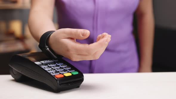 Customer Paying With NFC Technology by Smart Watch Contactless on Terminal alt
