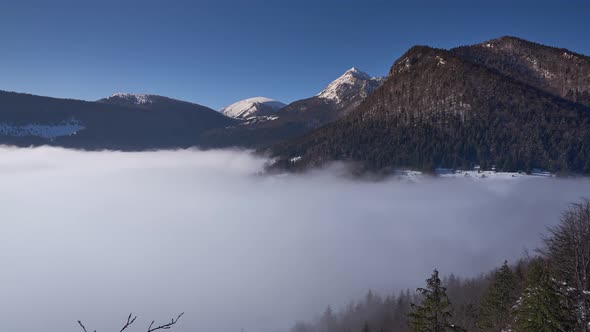 Winter mountain landscape in the Carpathians, low clouds moving to the valley.Snow-covered landscape alt