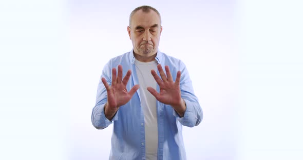 A Man Examines His Hands. Isolated on White Background. alt