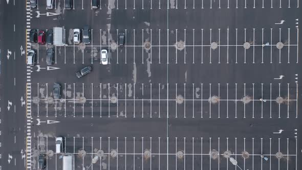 AERIAL: Empty Parking Lot with Only a Few Automobiles Parked 
