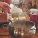 A Woman Pours Hot Soup for Guests - VideoHive Item for Sale