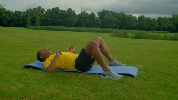 Athletic Motivated African American Man Doing Bodyweight Back Workout in Park alt