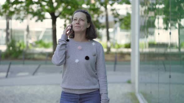 Happy Woman Talking on Phone Outdoor alt