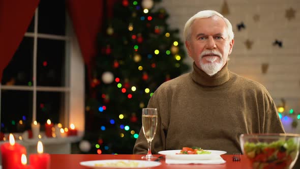 Sad Man Celebrating Xmas Alone, Looking to Camera, Social Services for Retirees alt