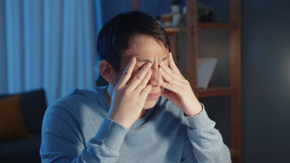 Asia businessman take a break hard work feel tired relax eyes after focus long time type computer. alt